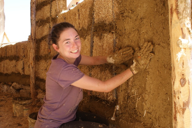 Clay plastering a straw bale wall